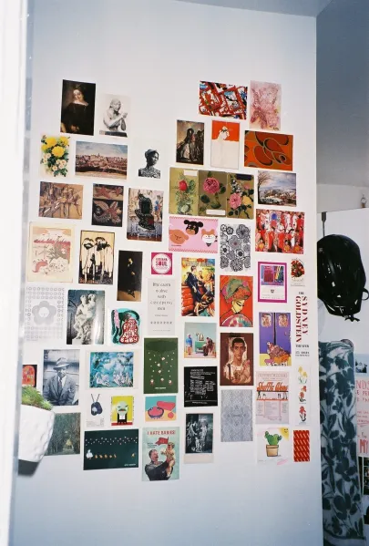 Postcards on a wall.