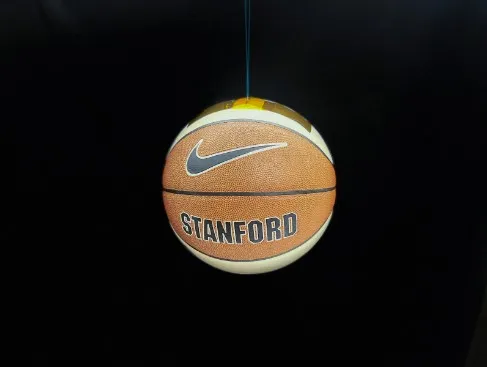 Black background with a basketball suspended in the air by a thin film that is Gecko adhesive