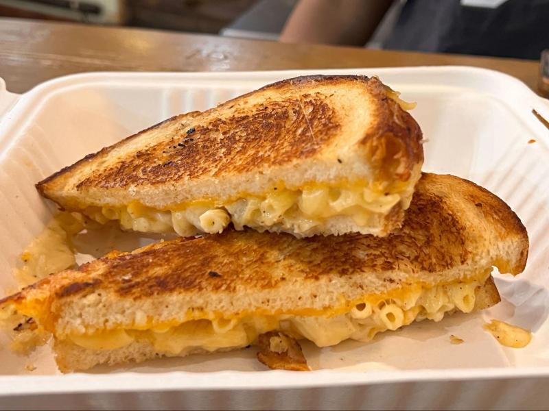 A grilled cheese sandwich with macaroni and cheese fillings.