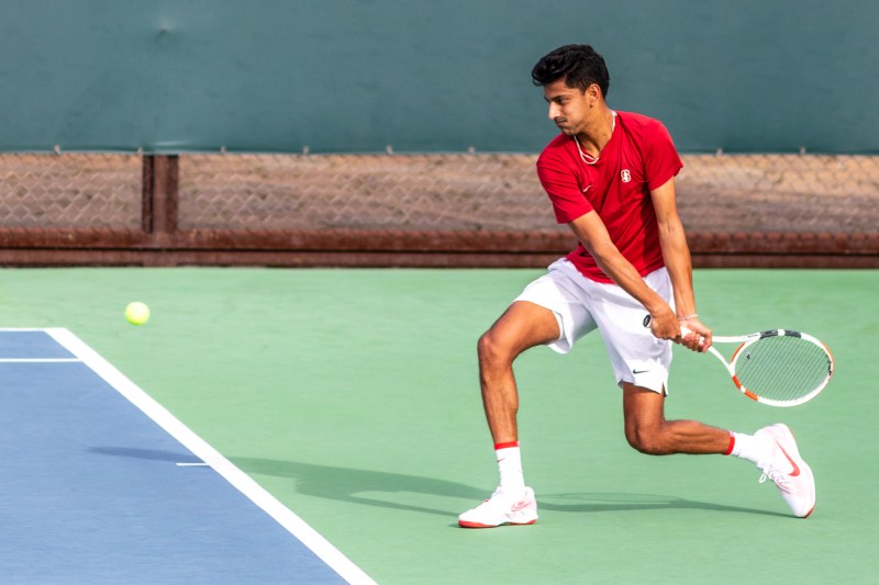 Neel Rajesh winds up to hit a backhand during a tennis match.