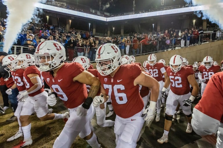 Stanford football players running