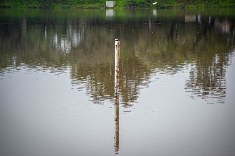 Picture of filled lake lag with a metal pole sticking out of it