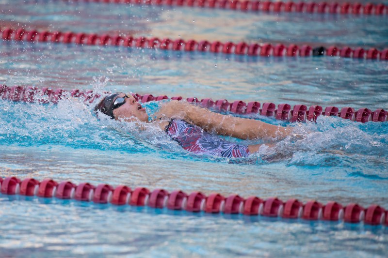 A female swimmer does the backstroke