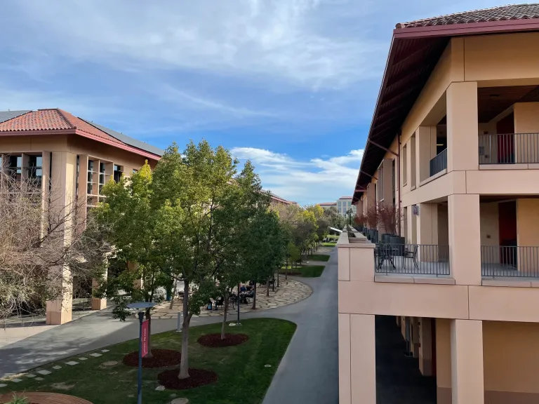 A photo from the balcony of a building at Knight Management Center; sky is light blue with some clouds