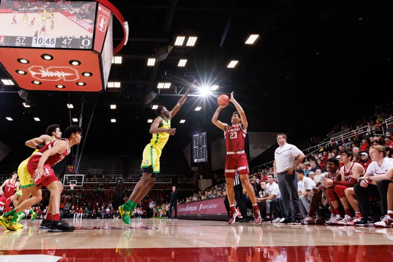 Brandon Angel jumps to shoot a 3-pointer during a basketball game.