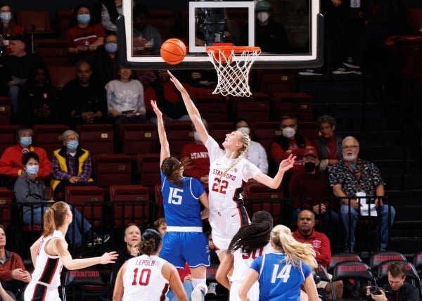 Cameron Brink extends her right arm to block a shot during a basketball game.