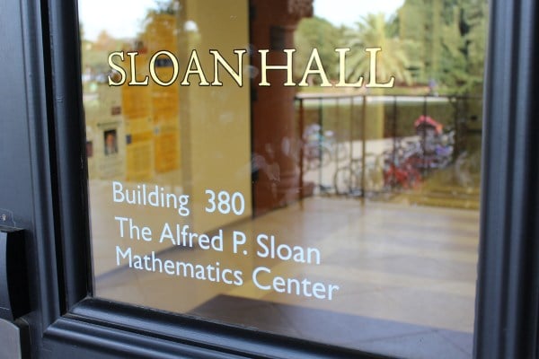 Close up picture of a door with the words "SLOAN HALL Building 380 The Alfred P. Sloan Mathematics Center"