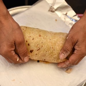 Close-up of Zaida rolling a tortilla.