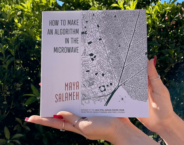 a photo of a book with a white cover and dark text that reads, "How to Make an Algorithm in the Microwave" and "Maya Salameh." there is also lineart that resembles a birds-eye view of a city and/or the circulatory system of a leaf