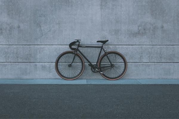A bike against a gray wall.