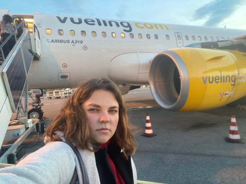 Girl frustrated in front of a plane