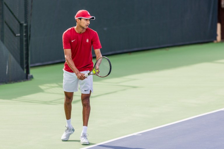 Samir Banerjee prepares to serve during a tennis match.