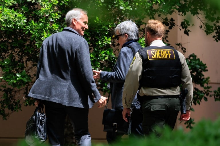 Stanford's president Marc Tessier Lavigne speaks to a sherif