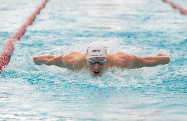 Andrei Minakov swims the butterfly during a swim meet.