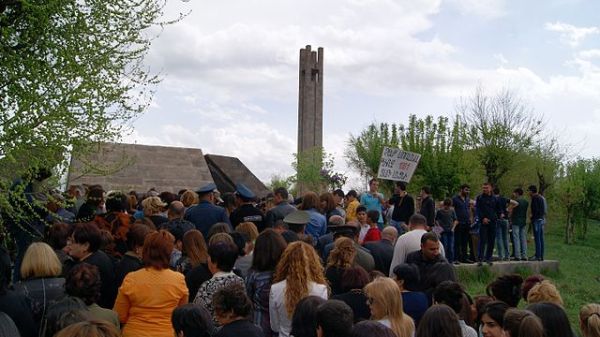 a crowd gathering outside a memorial