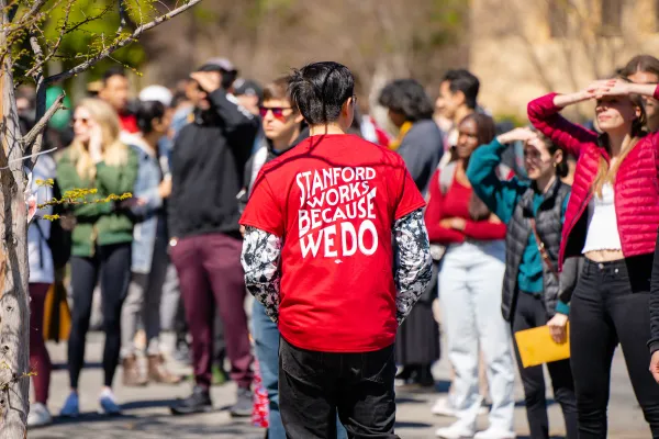 Student wearing Stanford Graduate Workers Union t-shirt at demonstration.