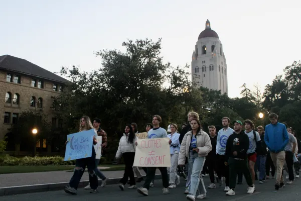 Students silently march past Hoover Tower.