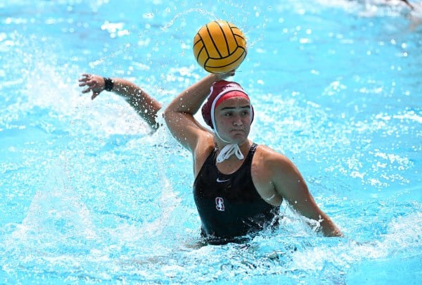 Jenna Flynn in the water, looking to throw the ball during a water polo game.