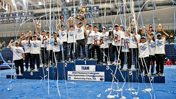 Stanford men's gymnastics celebrates on the podium as streamers fall to signify the victory.