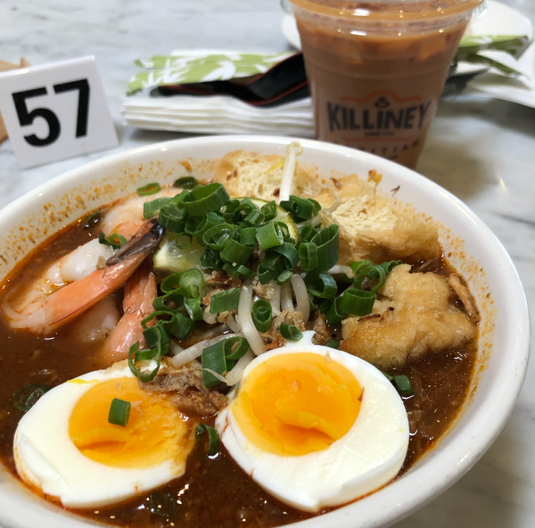 The mee siam noodle dish sits in front of a strongly brewed coffee and table number 57.