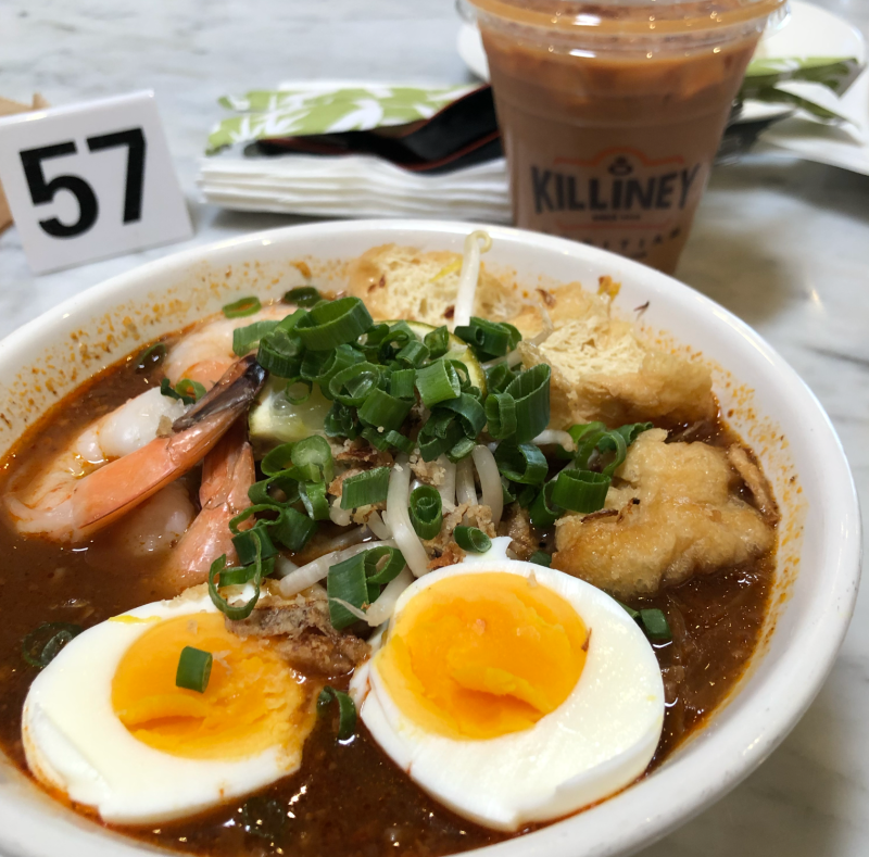 The mee siam noodle dish sits in front of a strongly brewed coffee and table number 57.