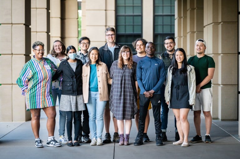 The 2023-2024 Graduate Student Council poses near an EVGR building