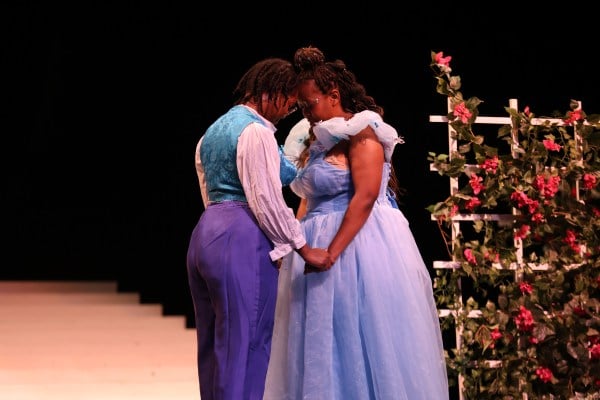Madison Amboise ’23 as Prince Christopher (left) and Sharon Wambu ’24, and Cinderella (right) embrace on stage of BLACKstage's production of "Cinderella."