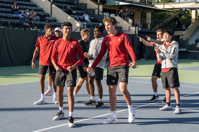 group of tennis players stand on the court