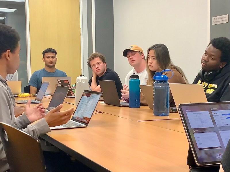 Members of the Undergraduate Senate sit around a table in discussion
