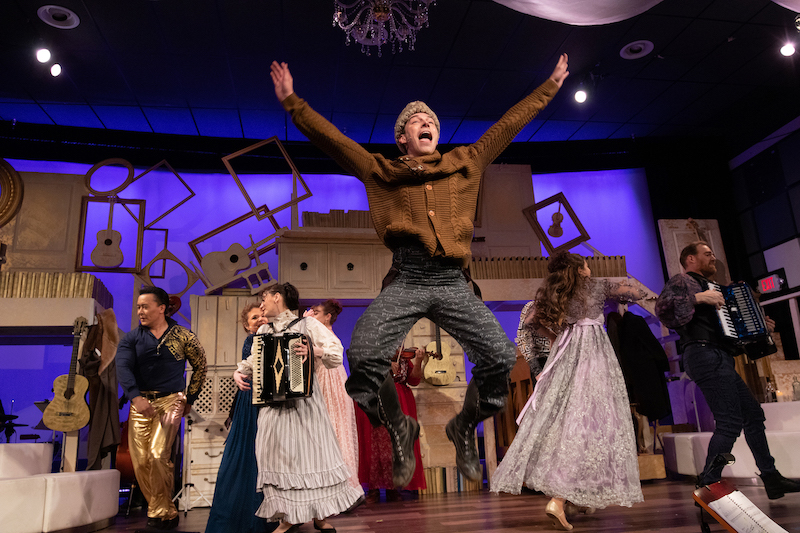 A boy jumps on stage as the cast of "Natasha, Pierre and the Great Comet of 1812" dances behind him. 