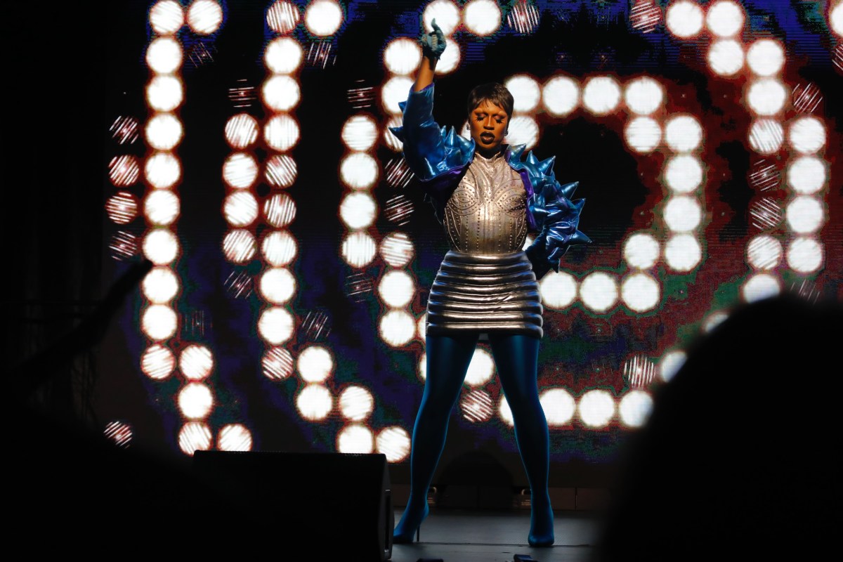 Shea Couleé performed an original song at Dragfest, donning a spiky blue top and metallic silver skirt on stage.