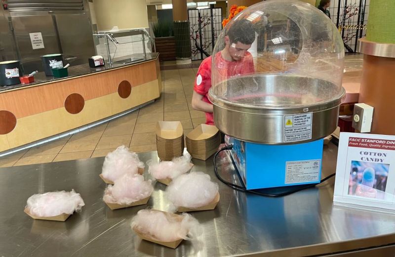 Cotton candy machine at Wilbur dining. Several tufts of cotton candy are on the metal table.