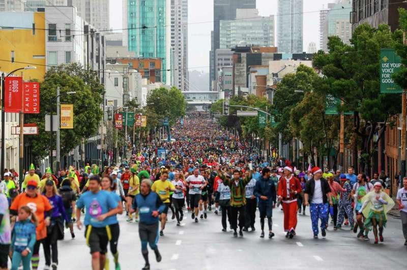 Participants run or walk at Howard and Ninth streets in San Francisco during the 2019 Bay to Breakers race.