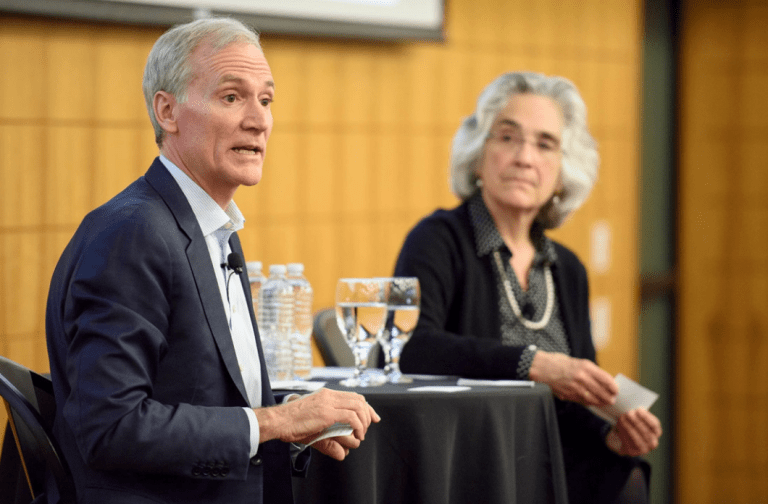 Persis Drell and Marc Tessier-Lavigne sitting together at a table.