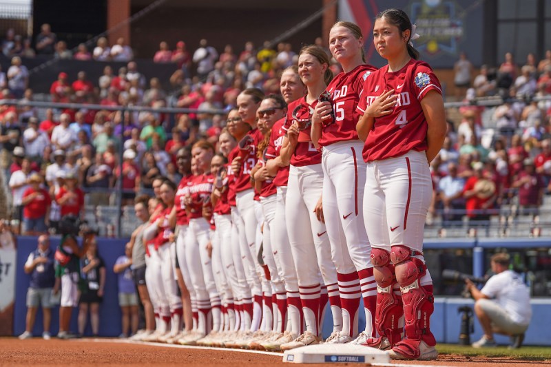 Stanford softball players stand for the national anthem