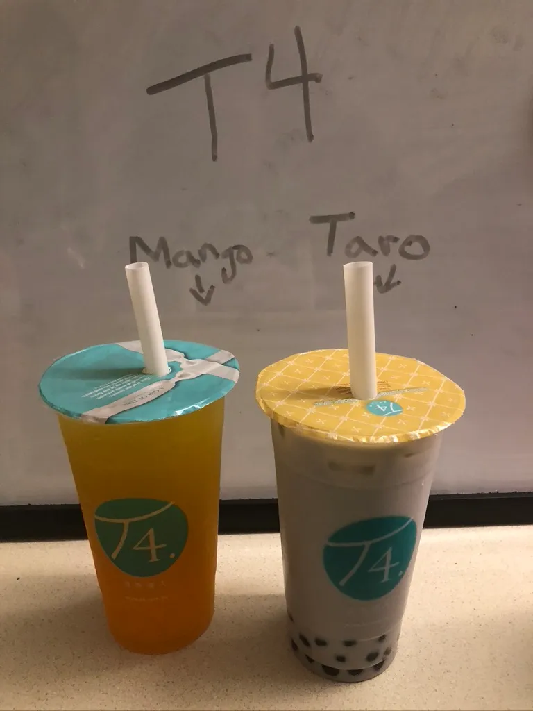The mango and taro teas from T4 sit on a table with labels pointing to each drink identifying them. 