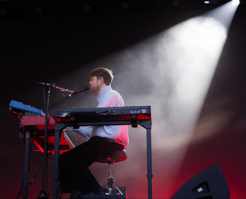 James Blake performed on stage with two electric pianos and a microphone.