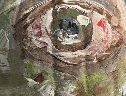 A painting of an eye done in swirls of gray, white, green and specks of red.