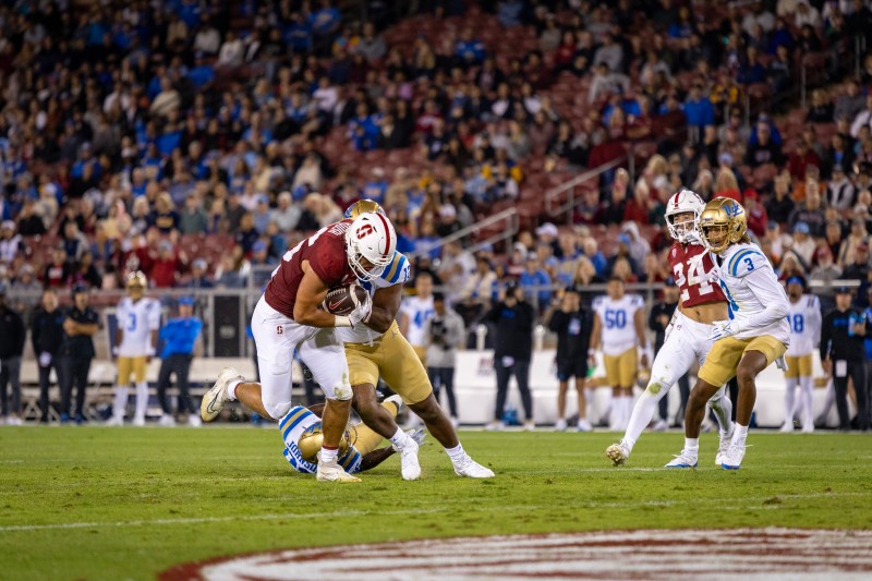 Stanford tight end Sam Roush is tackled by a UCLA defender. (Photo: AUDREY NGUYEN-HOANG/The Stanford Daily)