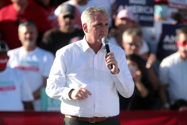 Kevin McCarthy holding a microphone with a crowd in the background