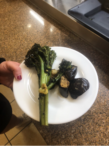 Broccolini overflows on a small plate.