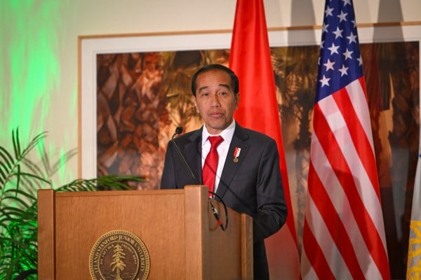 Indonesian President Joko Widodo gives a speech behind a podium, with the U.S. and Indonesian flags behind him.