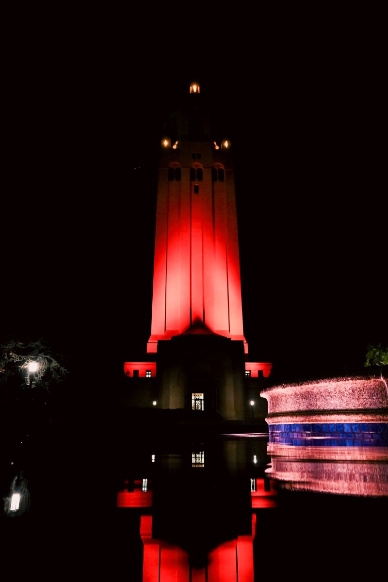 Hoover Tower with a red glow at night.