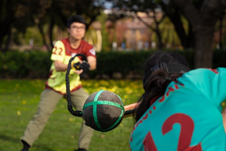 a foam ball and chain swings toward a player, who is ducking out of the way.