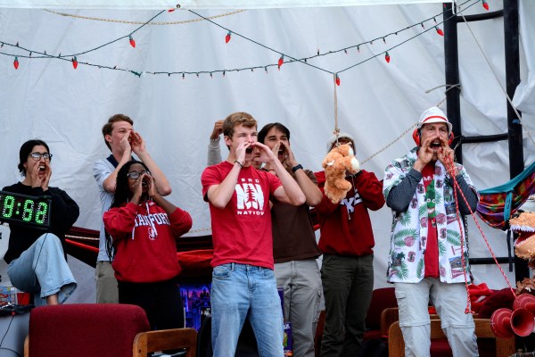 A photo of Stanford students dressed in red in a tent at White Plaza.