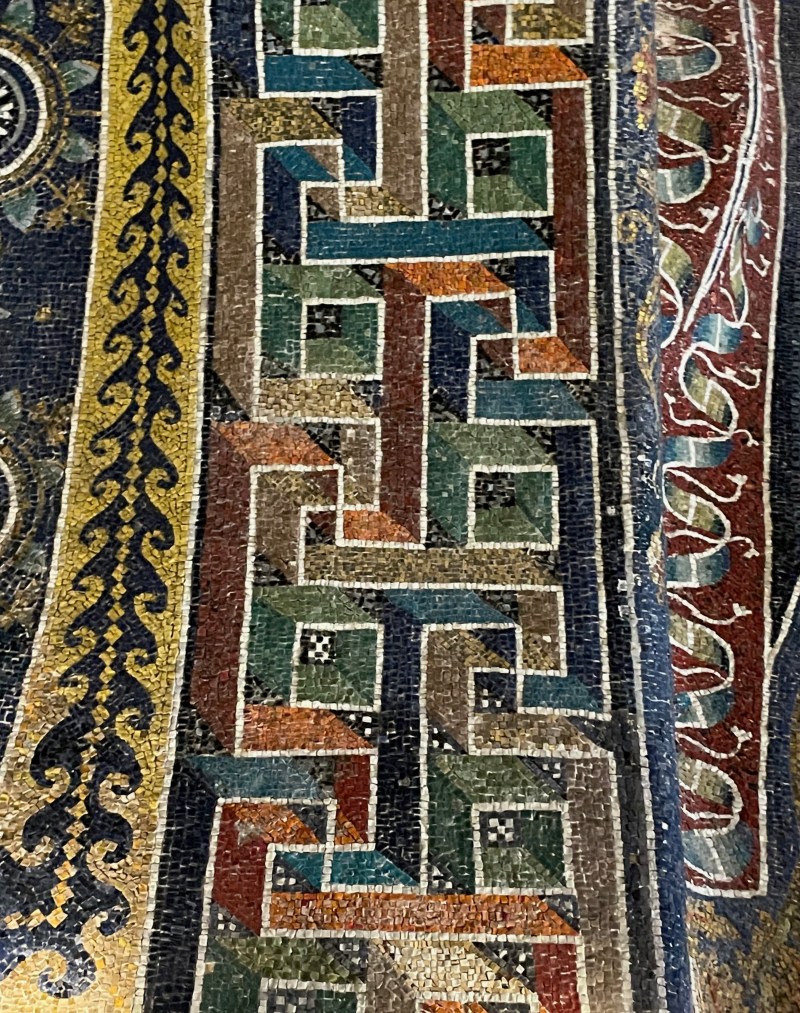 An image of three columns of distinct patterns, resembling a close-up of a rug.