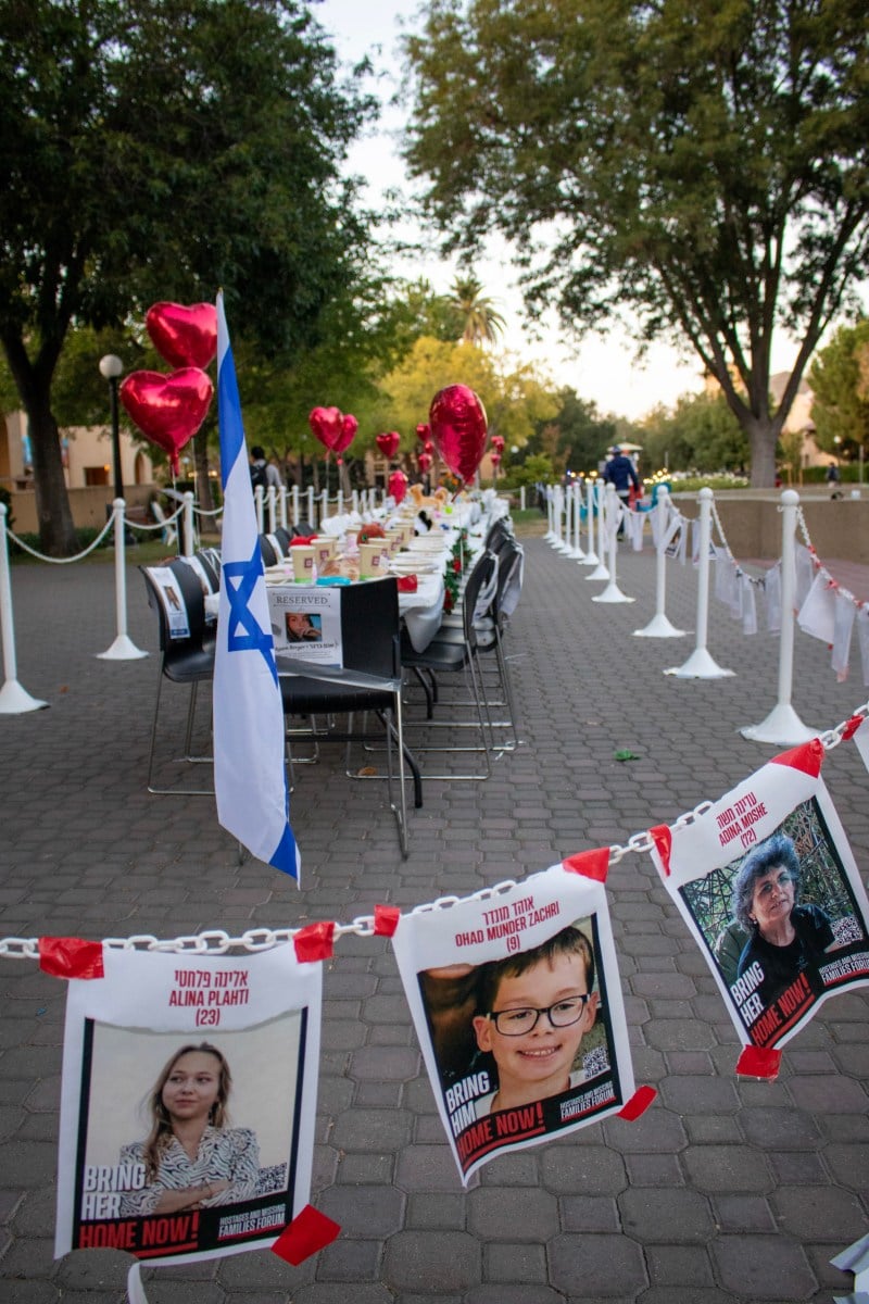 Empty Shabbat table honors hostages in front of Old Union