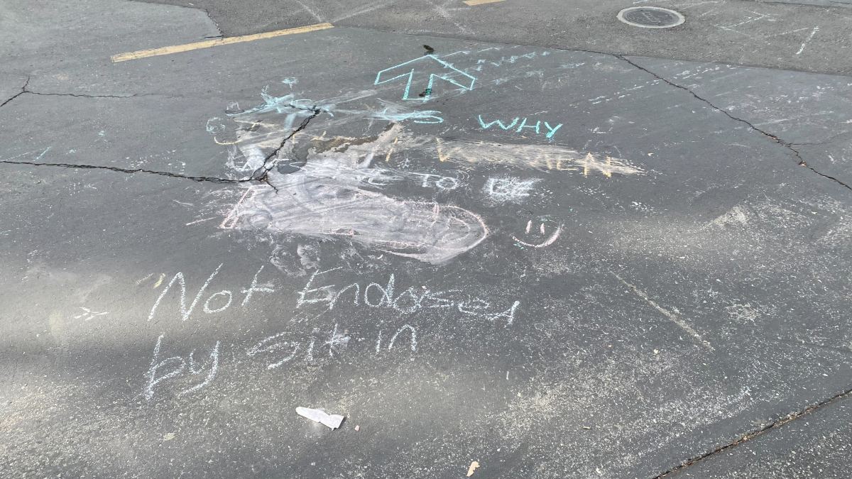A message chalked over and the words "not endorsed by sit-in written in chalk."