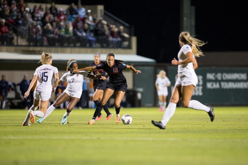 Sophomore midfielder Jasmine Aikey dribbles past Pepperdine's defenders. (Photo: SAMANTHA MILEWICZ/The Stanford Daily)
