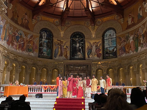A group of students stand at the center of memorial church.